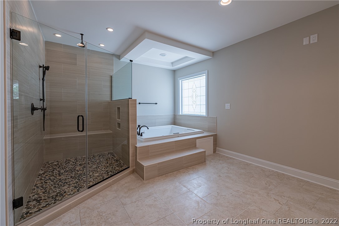 193 Kirk Road Aberdeen, NC 28315 - Photo 35 of 49 a spacious bathroom with a bathtub and shower
