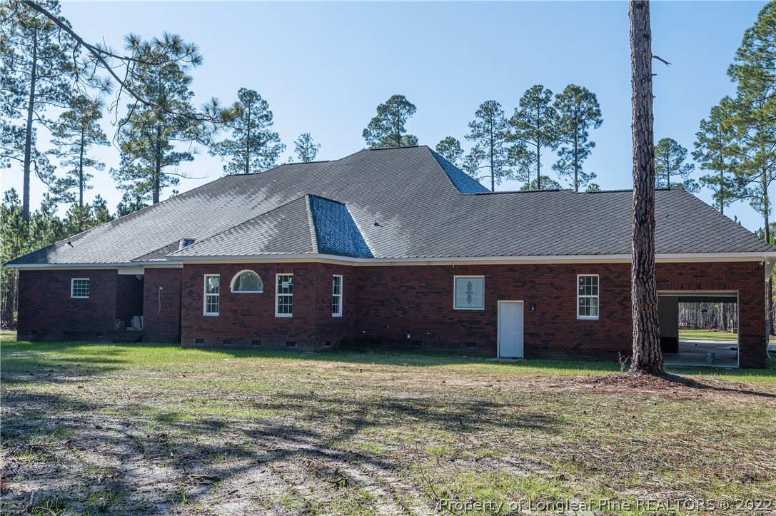 193 Kirk Road Aberdeen, NC 28315 - Photo 46 of 49 a view of a brick house with a yard and a large tree