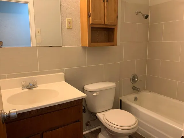 a bathroom with a sink a toilet and bathtub
