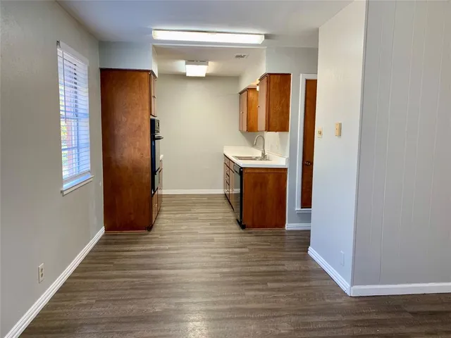 a view of kitchen and wooden floor