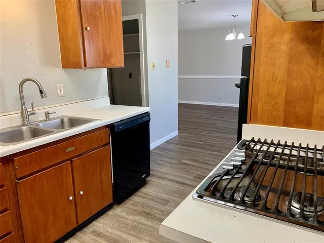 a kitchen with a sink and a refrigerator