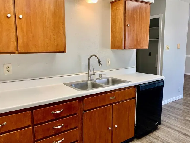 a kitchen with a sink and cabinets