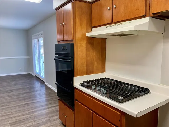 a stove top oven sitting inside of a kitchen