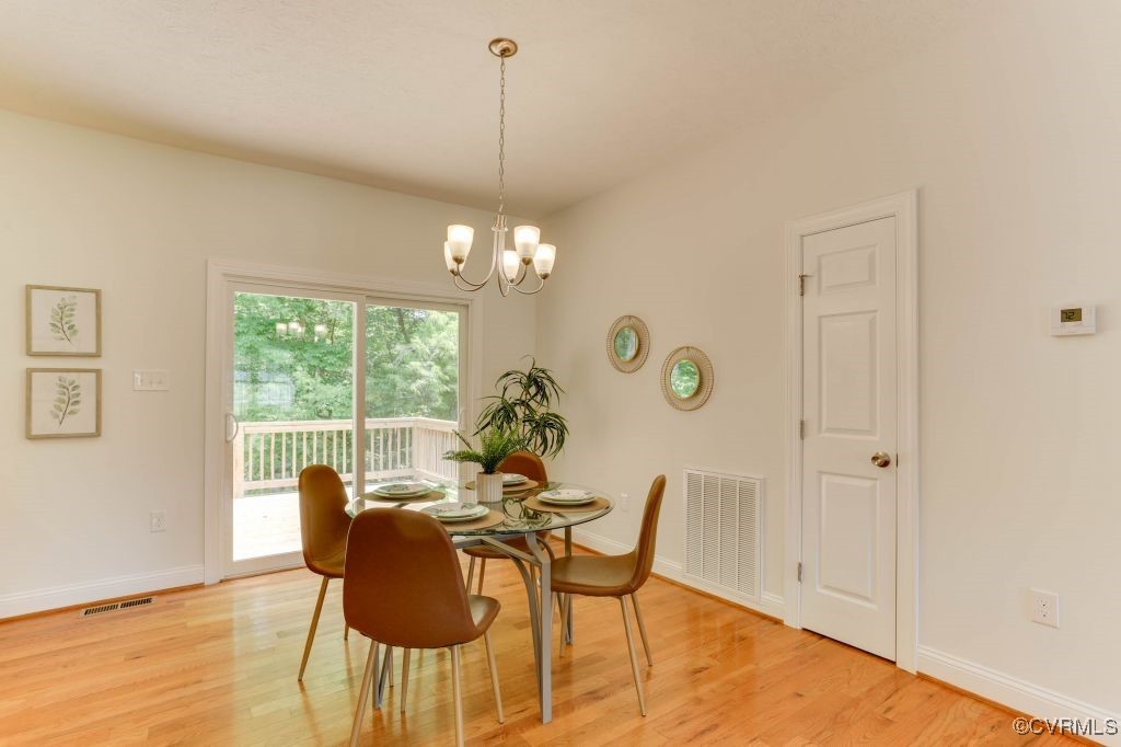 10907 New Town Road New Kent, VA 23124 - Photo 10 of 30 Dining space with a chandelier, light wood finishe