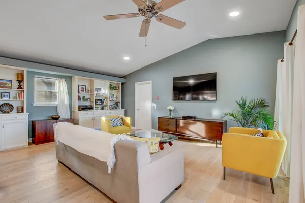 a living room with furniture ceiling fan and a rug