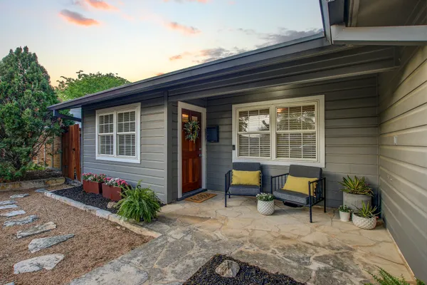 a view of a house with backyard sitting area and garden