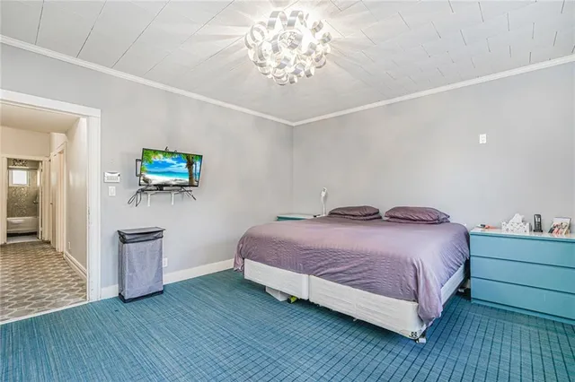 a bedroom with a bed and a chandelier