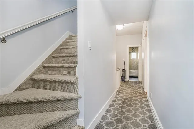 a view of a hallway with wooden floor and entryway