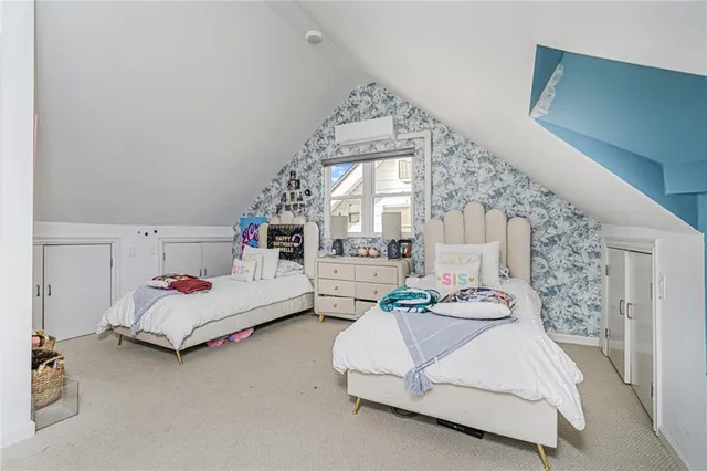 a bedroom with a bed couch and window