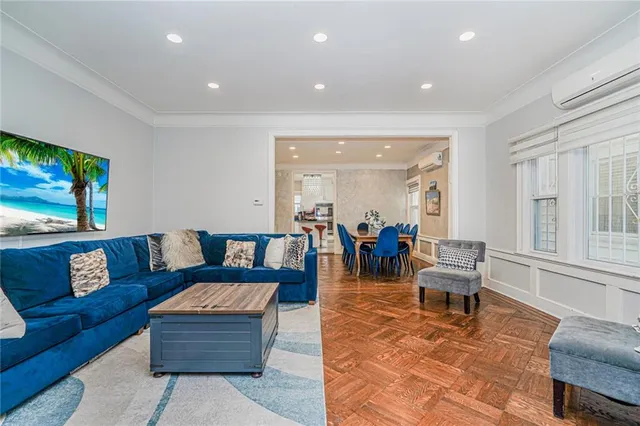 a living room with lots of furniture and painting on the wall