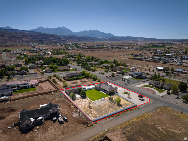 4635 East Sunny Acres Lane Moab, UT 84532 - Photo 11 of 56 Expansive property featuring a single-story residence, detached garage, and a large manicured lawn
