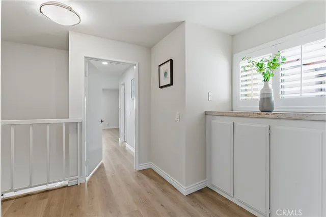 a view of hallway with wooden floor