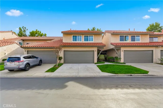 a front view of a house with a yard and a garage