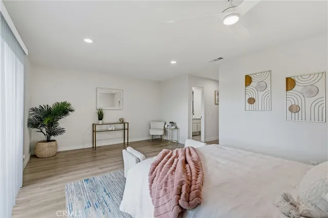 a bedroom with furniture and a potted plant