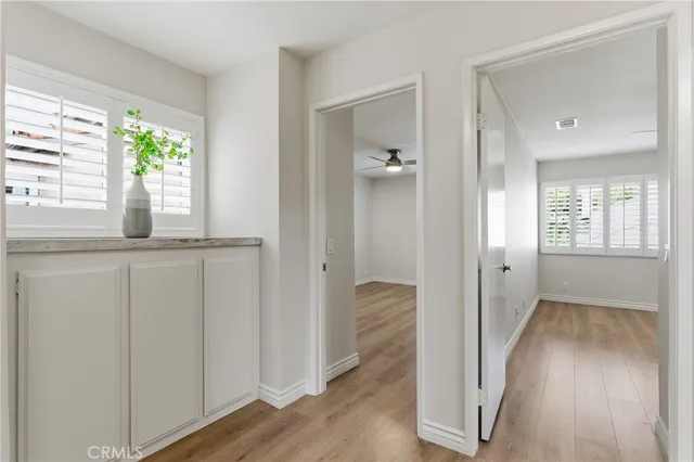 a view of hallway with wooden floor