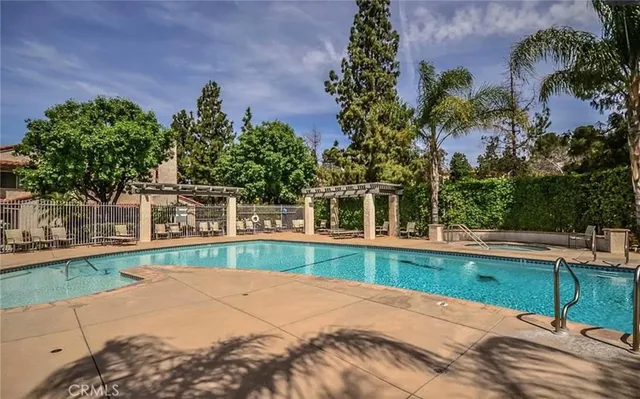 a view of a house with a yard and potted plants