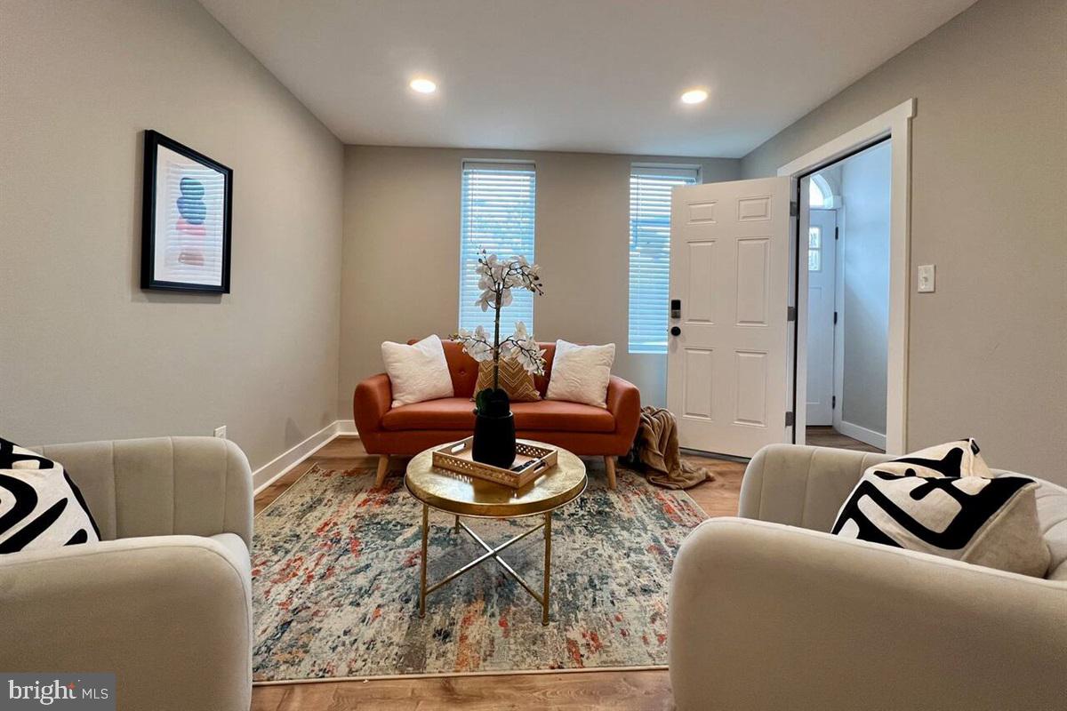 215 West 6th Street, Unit 1 Wilmington, DE 19801 - Photo 1 of 10 a living room with furniture a rug and a table