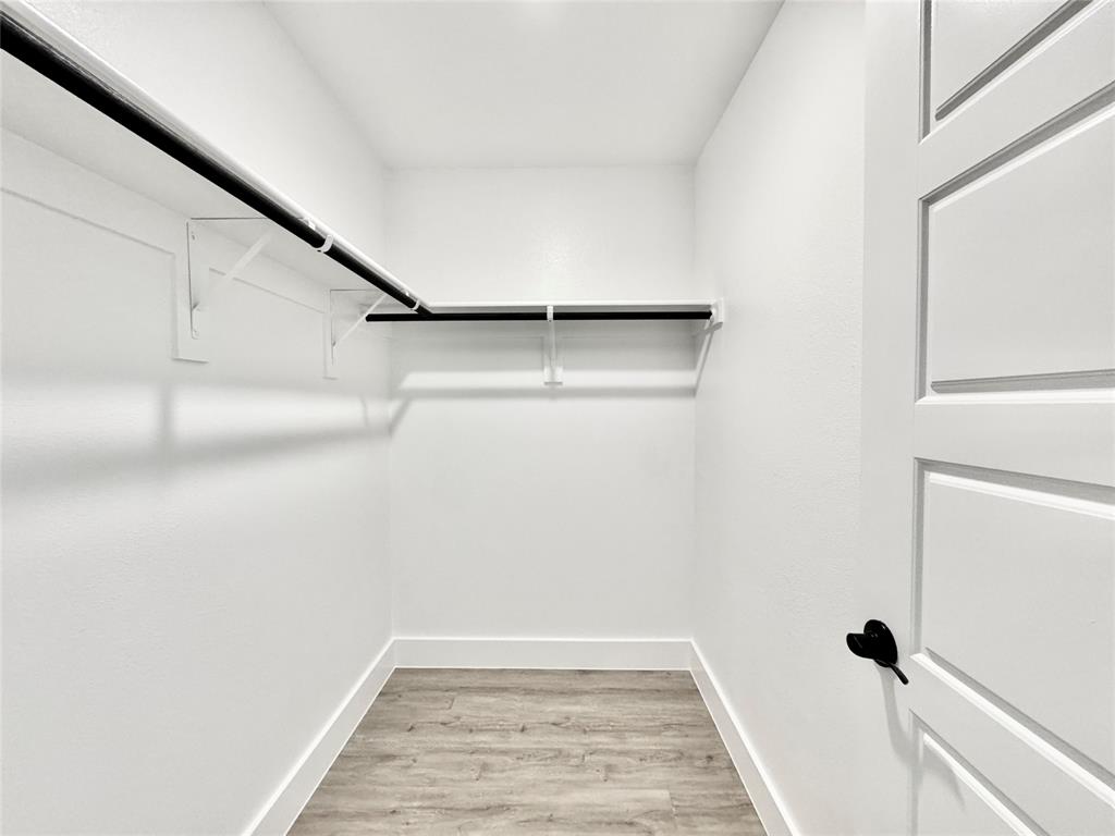8509 Shorehan Road The Colony, TX 75056 - Photo 26 of 33 Walk in closet featuring light wood-type flooring