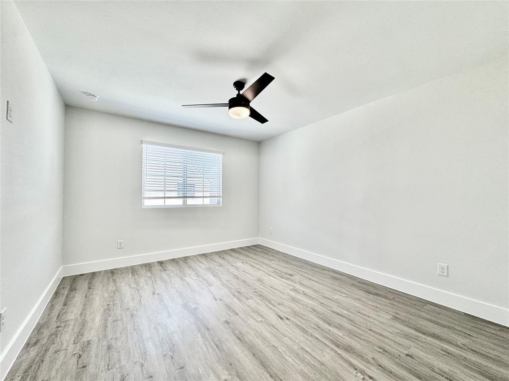 8509 Shorehan Road The Colony, TX 75056 - Photo 27 of 33 Spare room featuring wood finished floors, ceiling fan, and baseboards