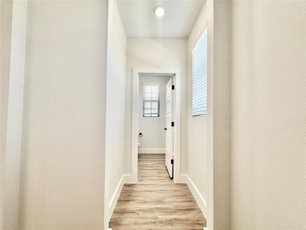 8509 Shorehan Road The Colony, TX 75056 - Photo 10 of 33 Corridor featuring light wood-style floors and baseboards