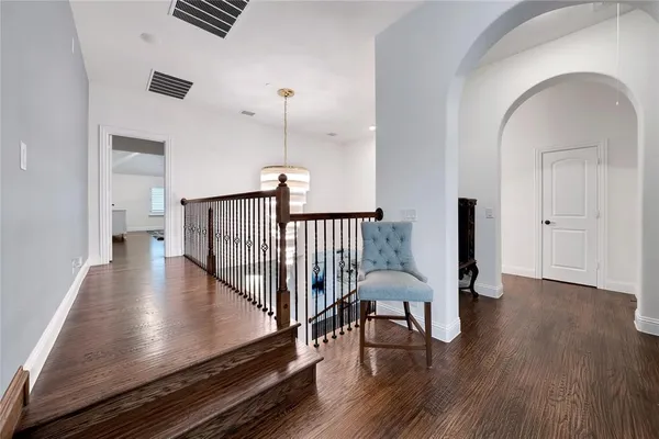 a view of a livingroom with furniture wooden floor a chandelier