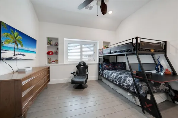 a bedroom with a bed and a chandelier