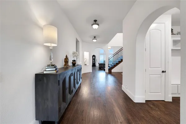a view of a hallway view with wooden floor and staircase