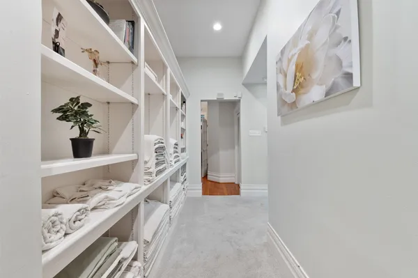 a spacious bedroom with a bed and a chandelier