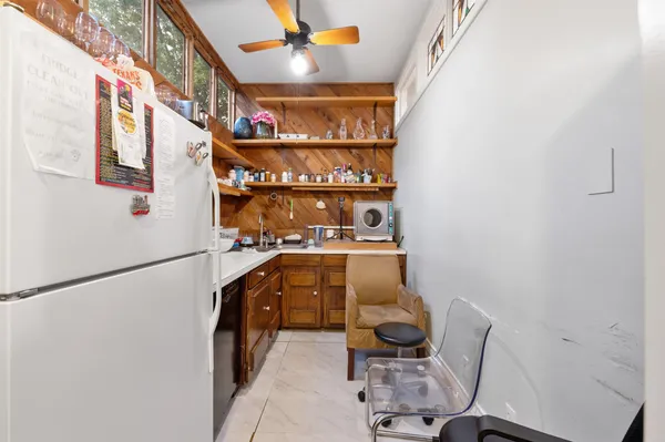 a bedroom with a bed and a flat tv screen on the dresser