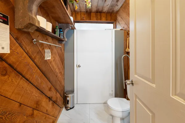 a bedroom with two beds and a chair