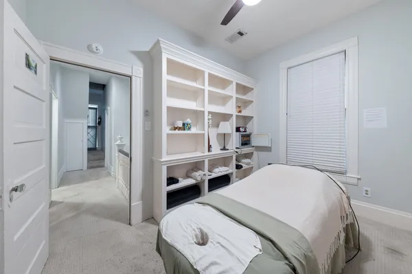a view of a house with a yard and wooden fence