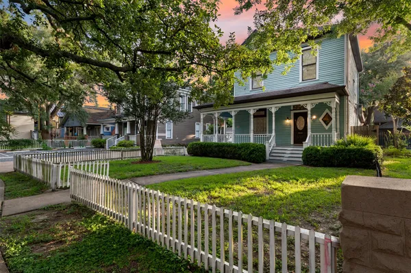 a front view of a house with a yard table and chairs
