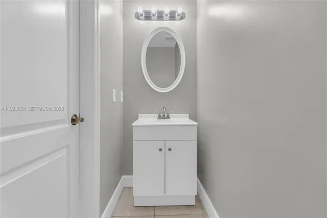 a white toilet sitting in a bathroom next to a sink