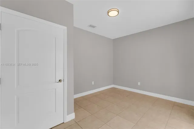 a view of an empty room with glass door