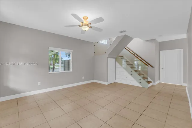 a view of an empty room with windows