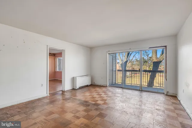 an empty room with windows and closet