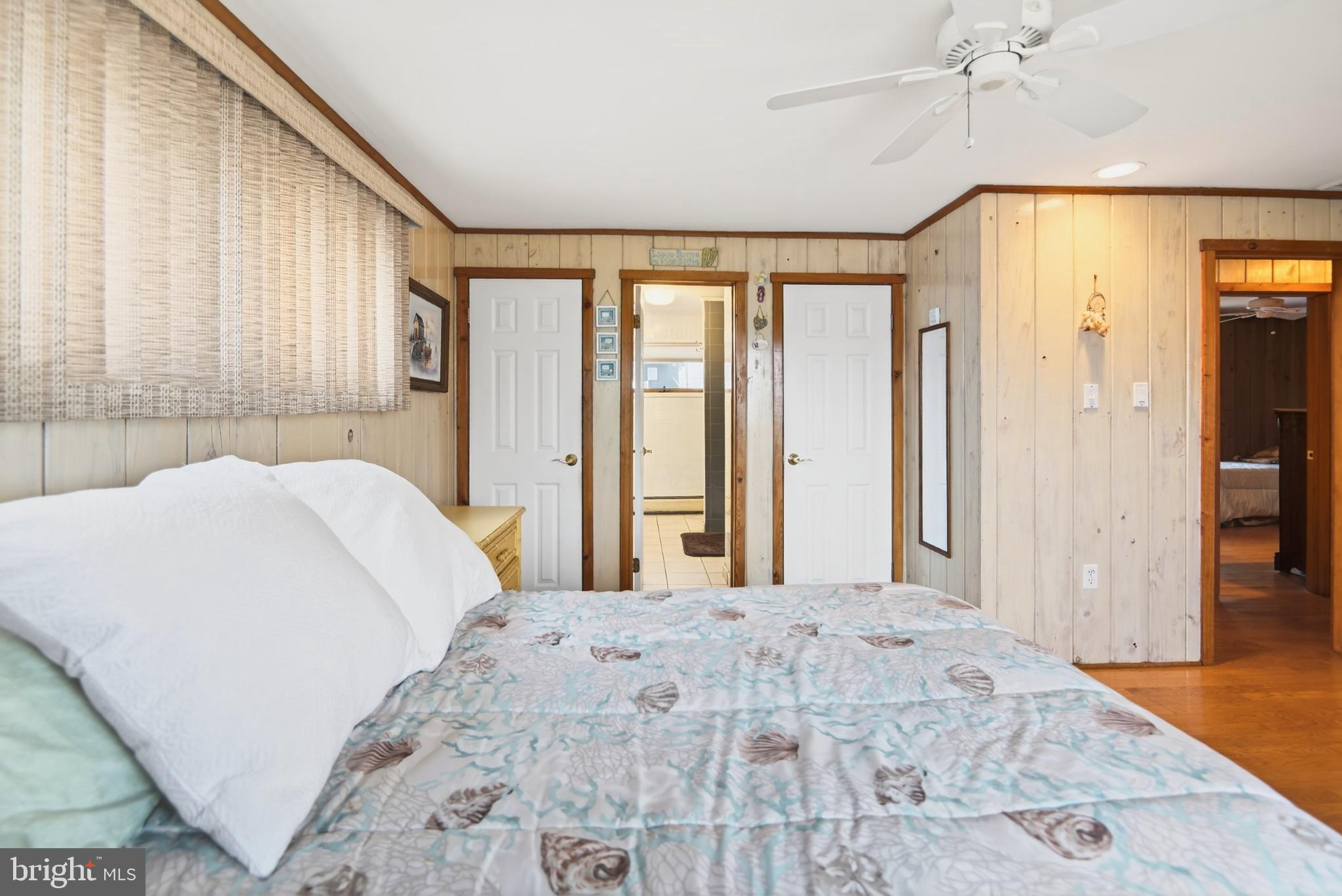 4 Rona Lane Manahawkin, NJ 08050 - Photo 18 of 28 a bedroom with a large bed and a large window