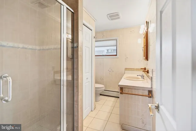 a bathroom with a sink toilet and a mirror