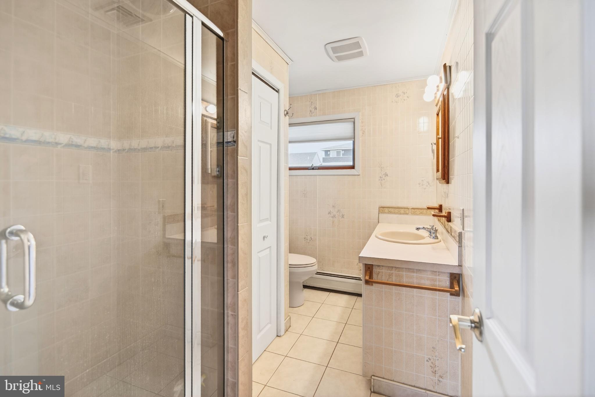 4 Rona Lane Manahawkin, NJ 08050 - Photo 24 of 28 a bathroom with a sink toilet and a mirror