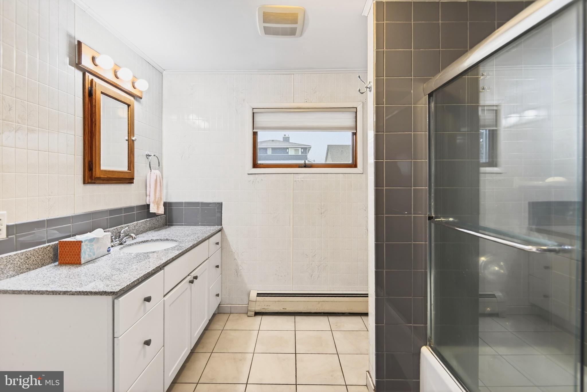 4 Rona Lane Manahawkin, NJ 08050 - Photo 25 of 28 a bathroom with a sink and a mirror