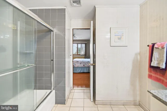 a bathroom with a glass shower door