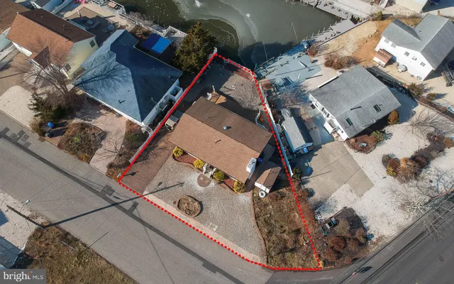 an aerial view of a house with a backyard