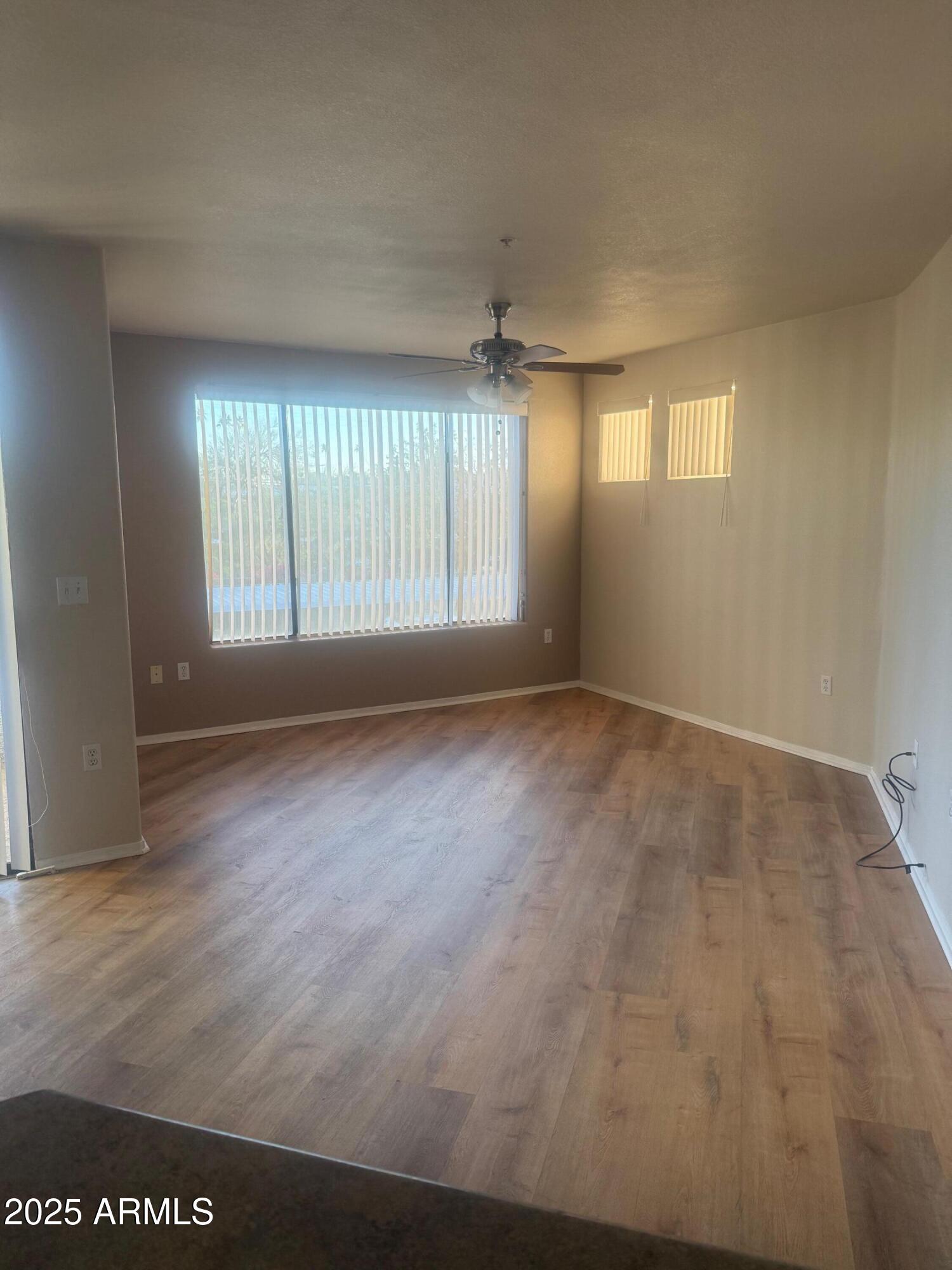 3848 North 3rd Avenue, Unit 2071 Phoenix, AZ 85013 - Photo 12 of 31 an empty room with wooden floor and windows