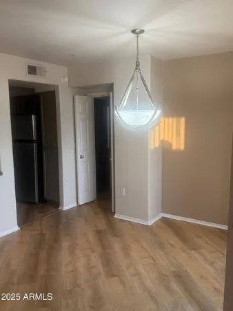 a view of a room with wooden floor and windows