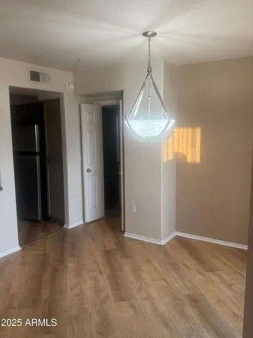 a view of a room with wooden floor and windows