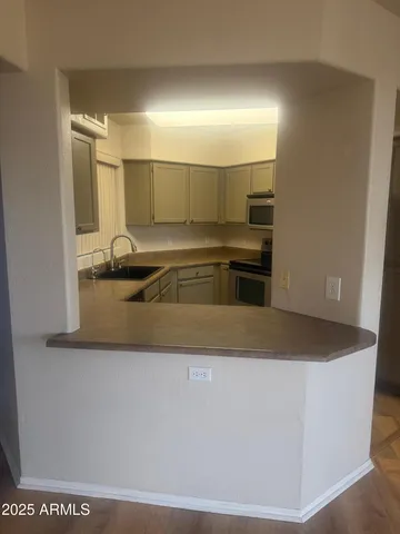 a kitchen with kitchen island a sink a stove and a refrigerator