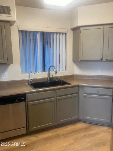 a kitchen with a sink and cabinets