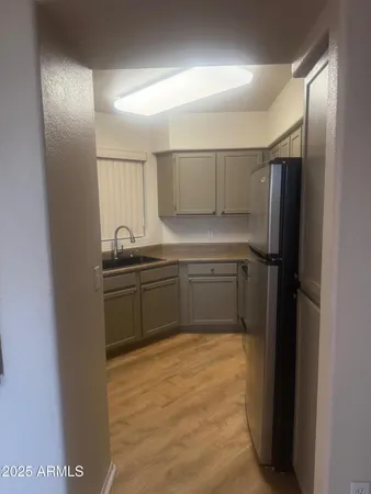 a kitchen with a sink and refrigerator