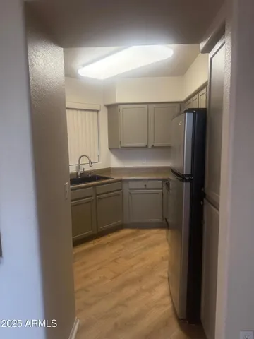 a kitchen with a sink and refrigerator