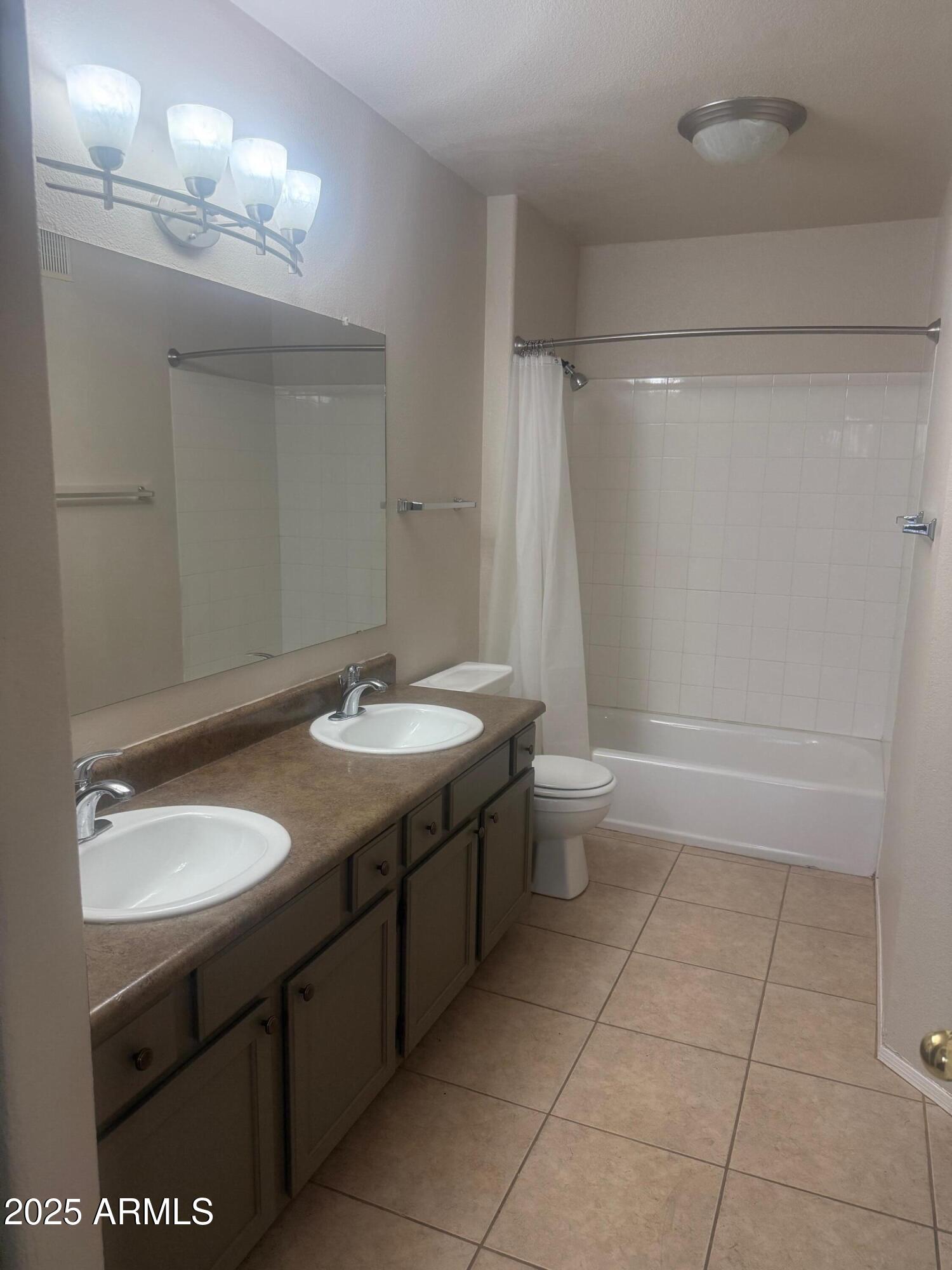 3848 North 3rd Avenue, Unit 2071 Phoenix, AZ 85013 - Photo 21 of 31 a bathroom with a double vanity sink toilet and a mirror